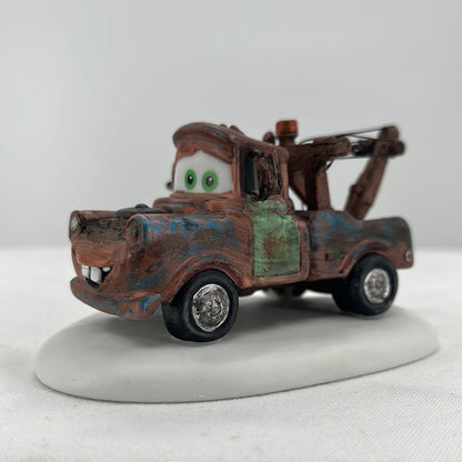 Department 56 North Pole Series Disney Pixar Cars Mater Christmas to You, Too!, side view.