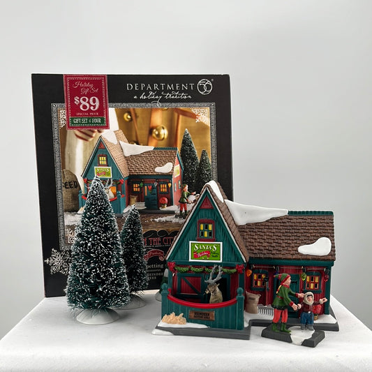 Department 56 Christmas in the City Santa’s Reindeer Petting Stable “Feeding the Reindeer” (set of 4) with packaging, building and accessories, front view.