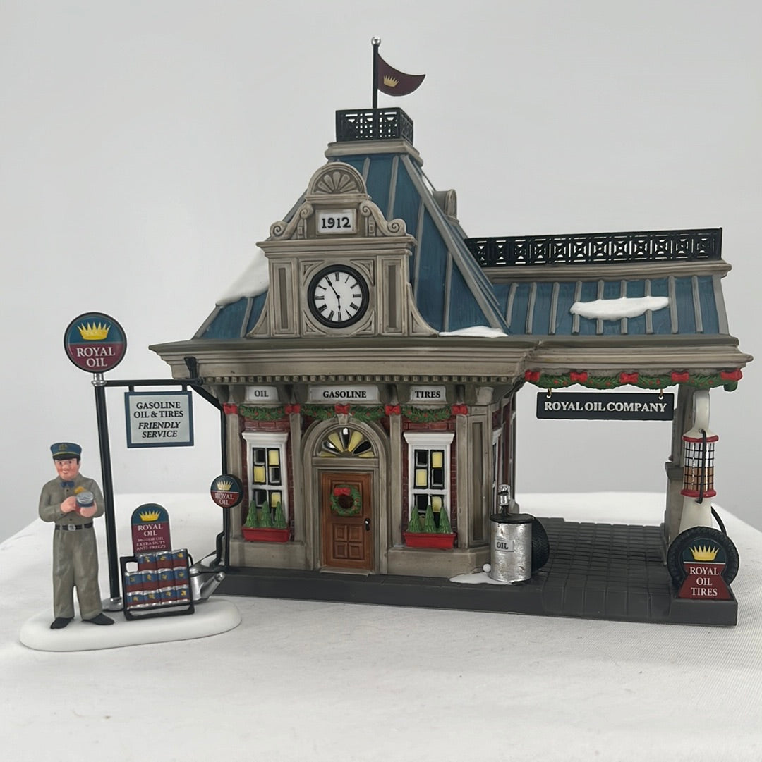 Department 56 Christmas in the City Royal Oil Company (Set of 2) lighted building and accessory, front view.