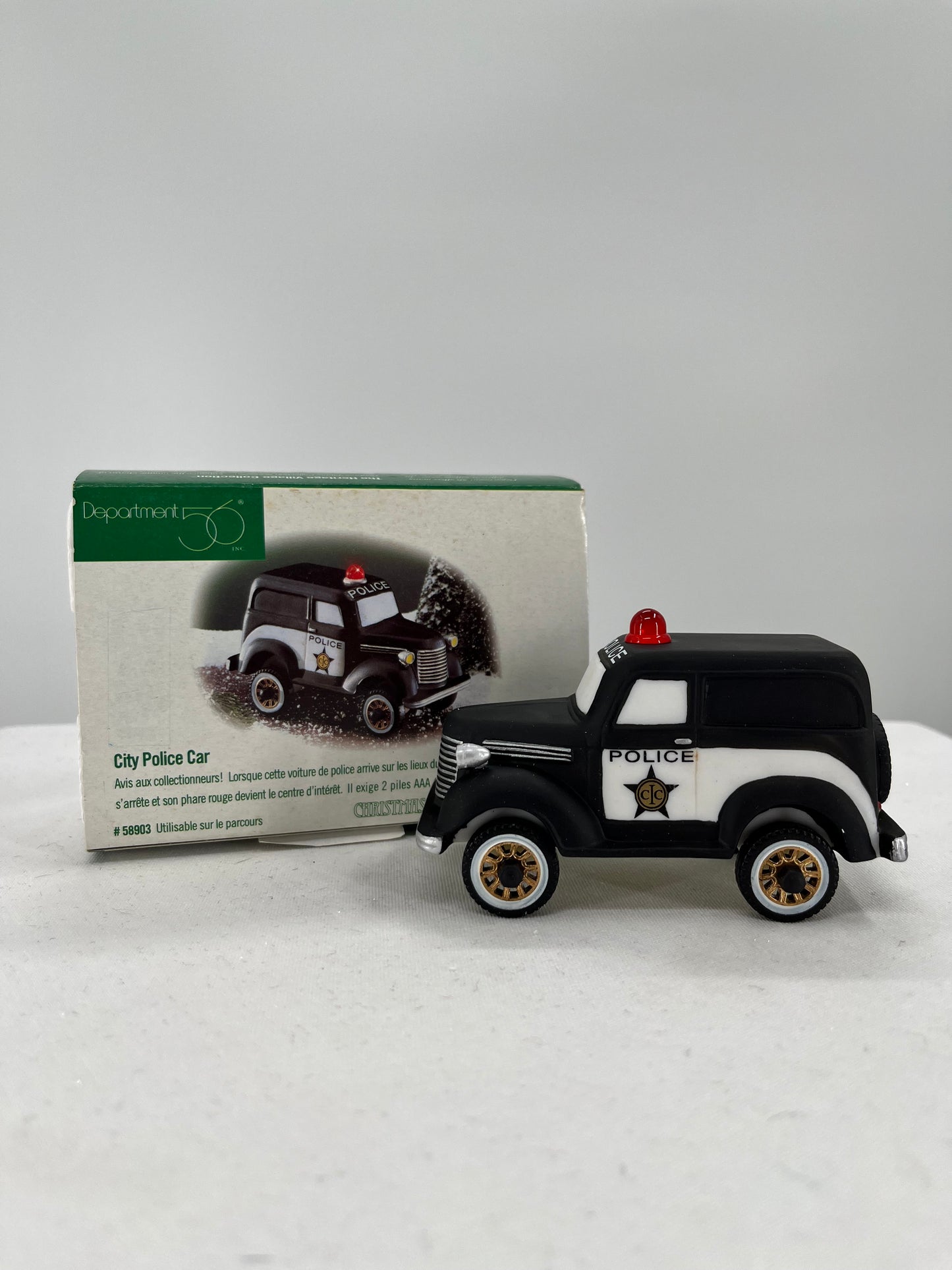 Department 56 Snow Village City Police Car figurine, side view.